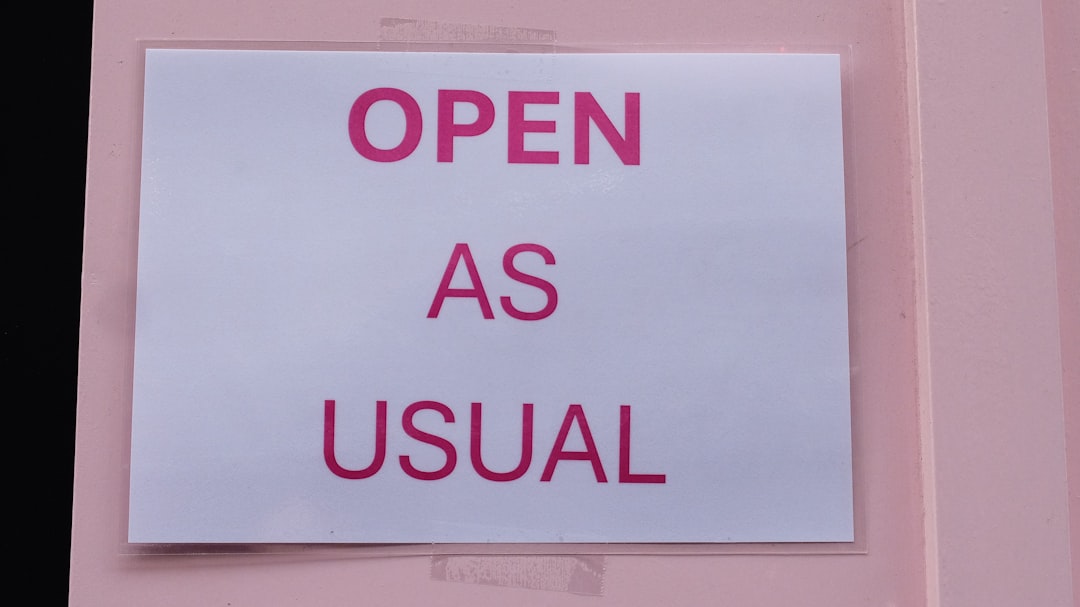 A sign on a door that says open as usual,