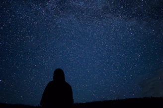 A person looking up at the stars in the sky