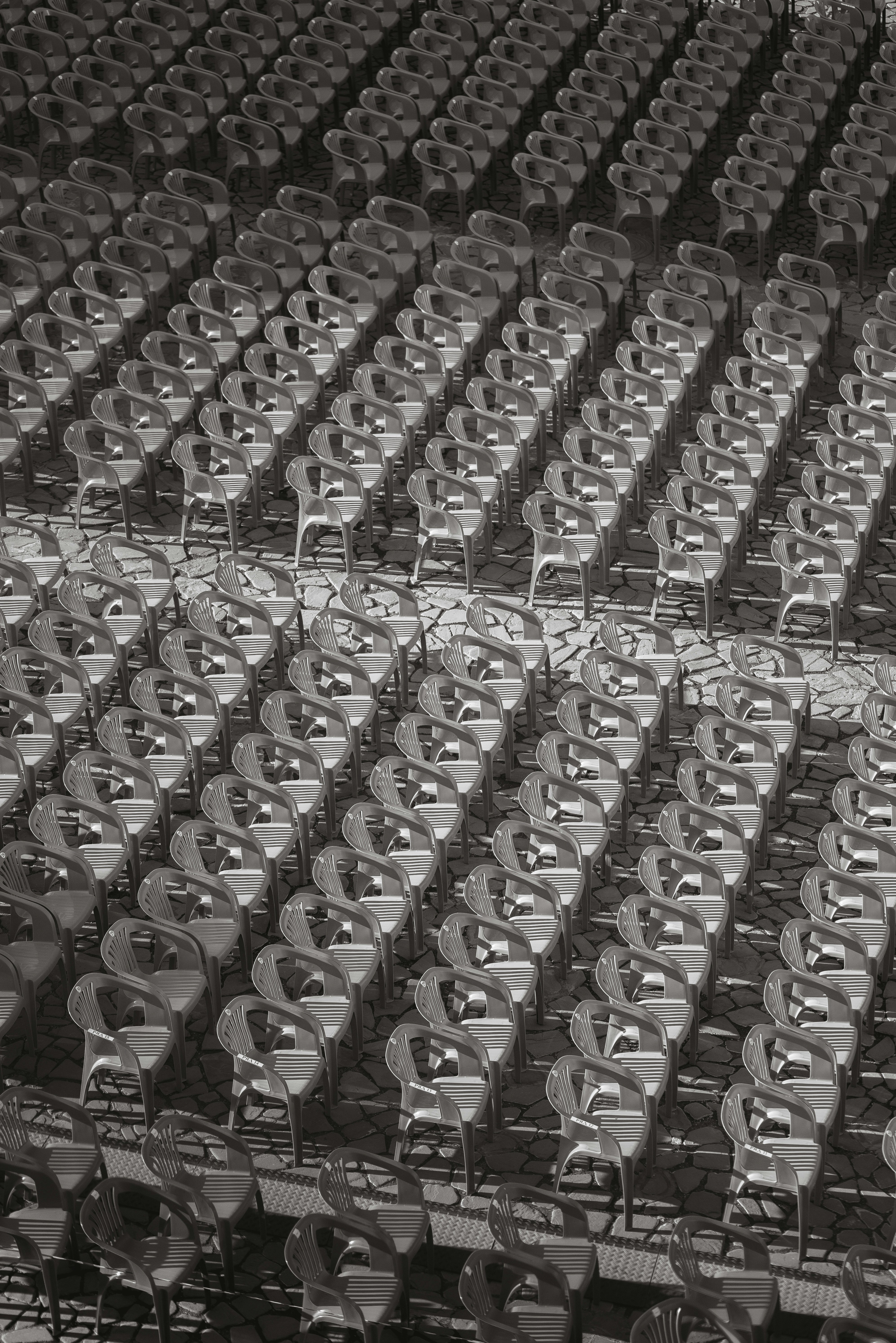 A black and white photo of empty seats in a stadium