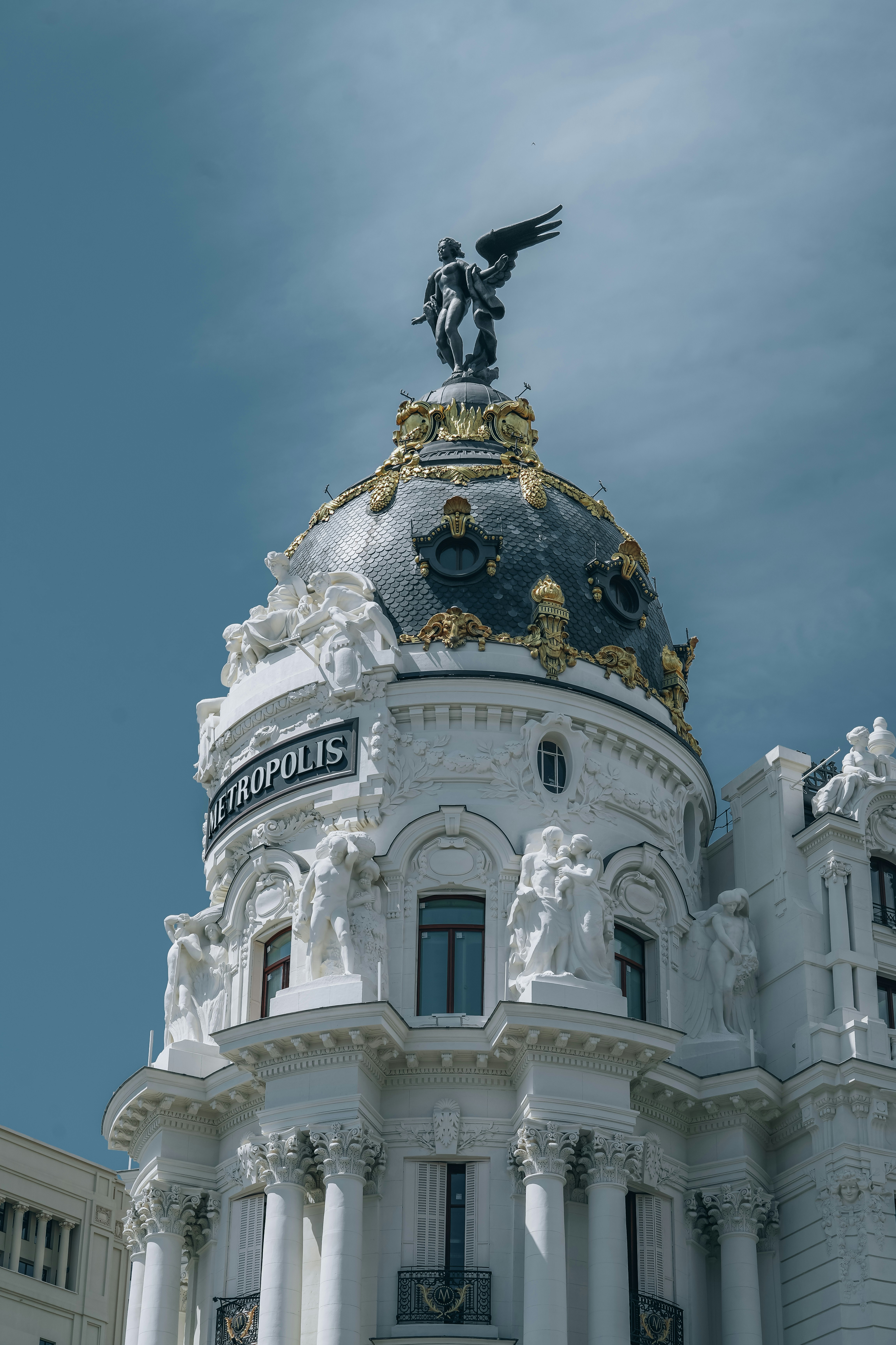 A large white building with a statue on top of it