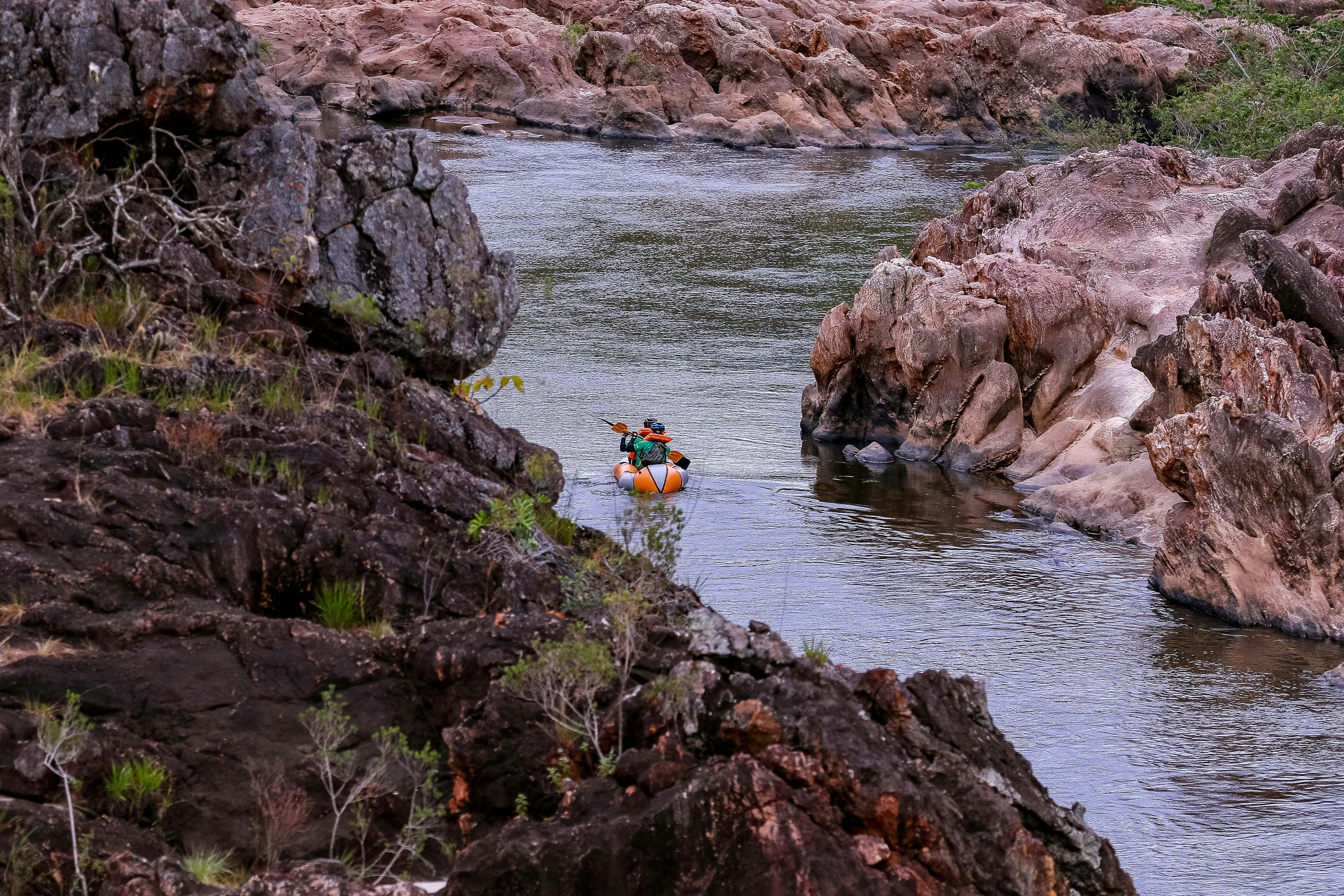 A couple of people in a small boat on a river