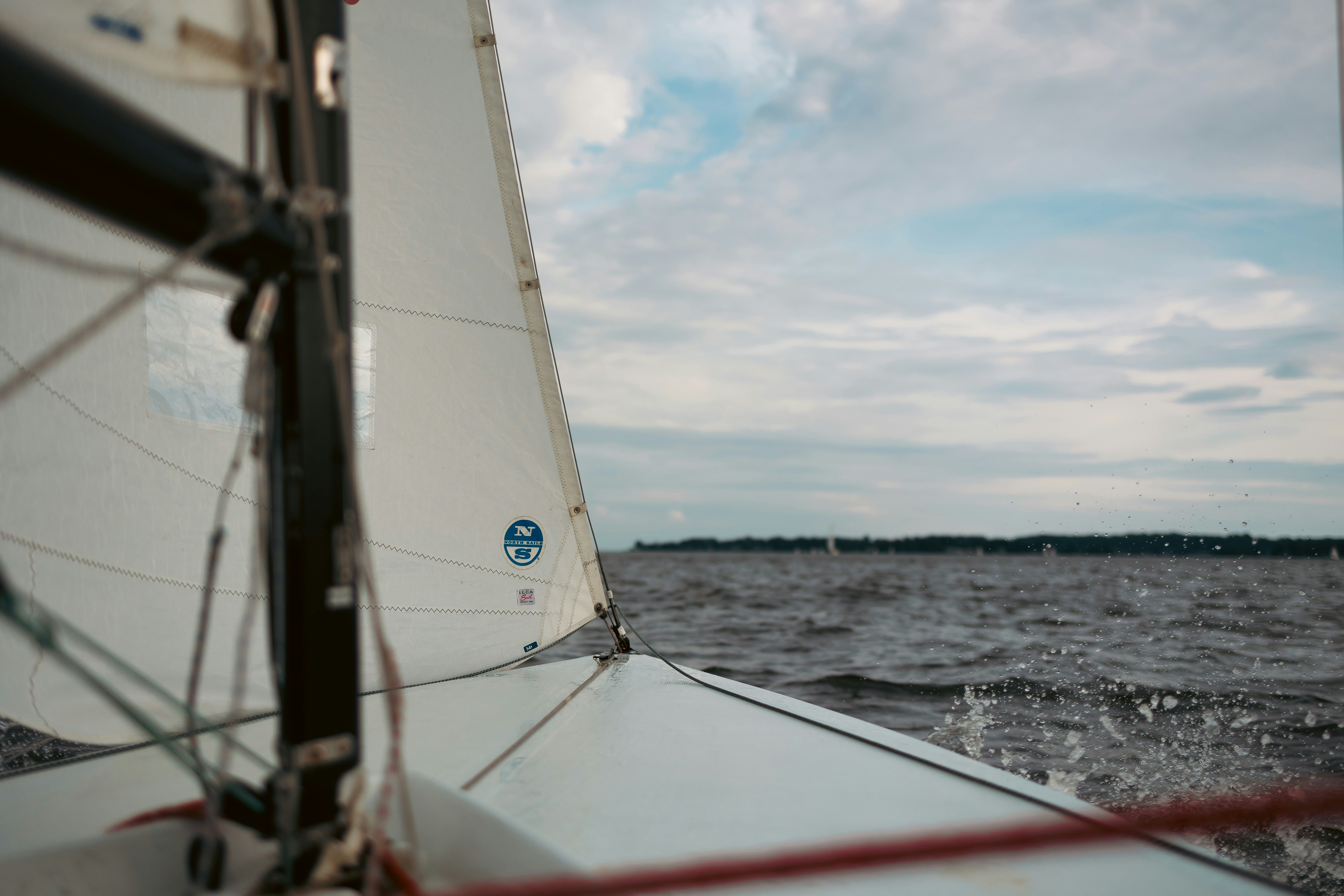 A sailboat sailing across a body of water