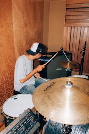 A man sitting in front of a drum set