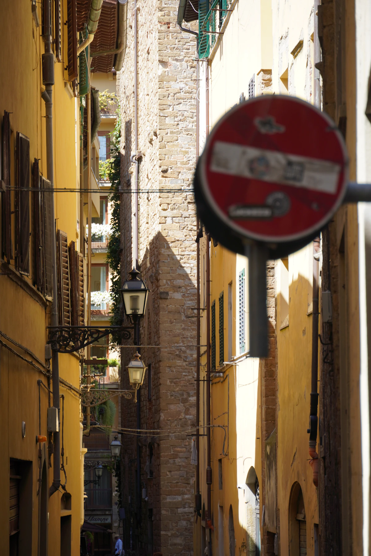 A narrow lane between old ochre buildings in Florence