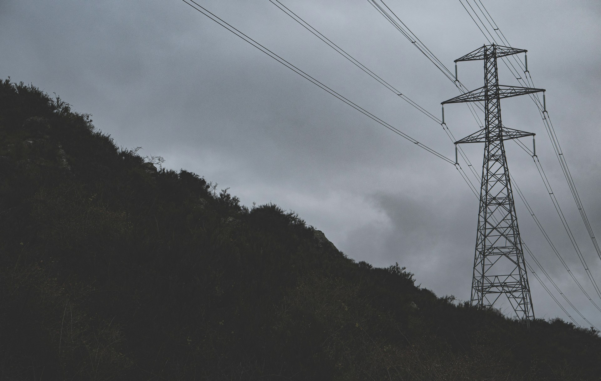 A couple of power lines sitting on top of a hill