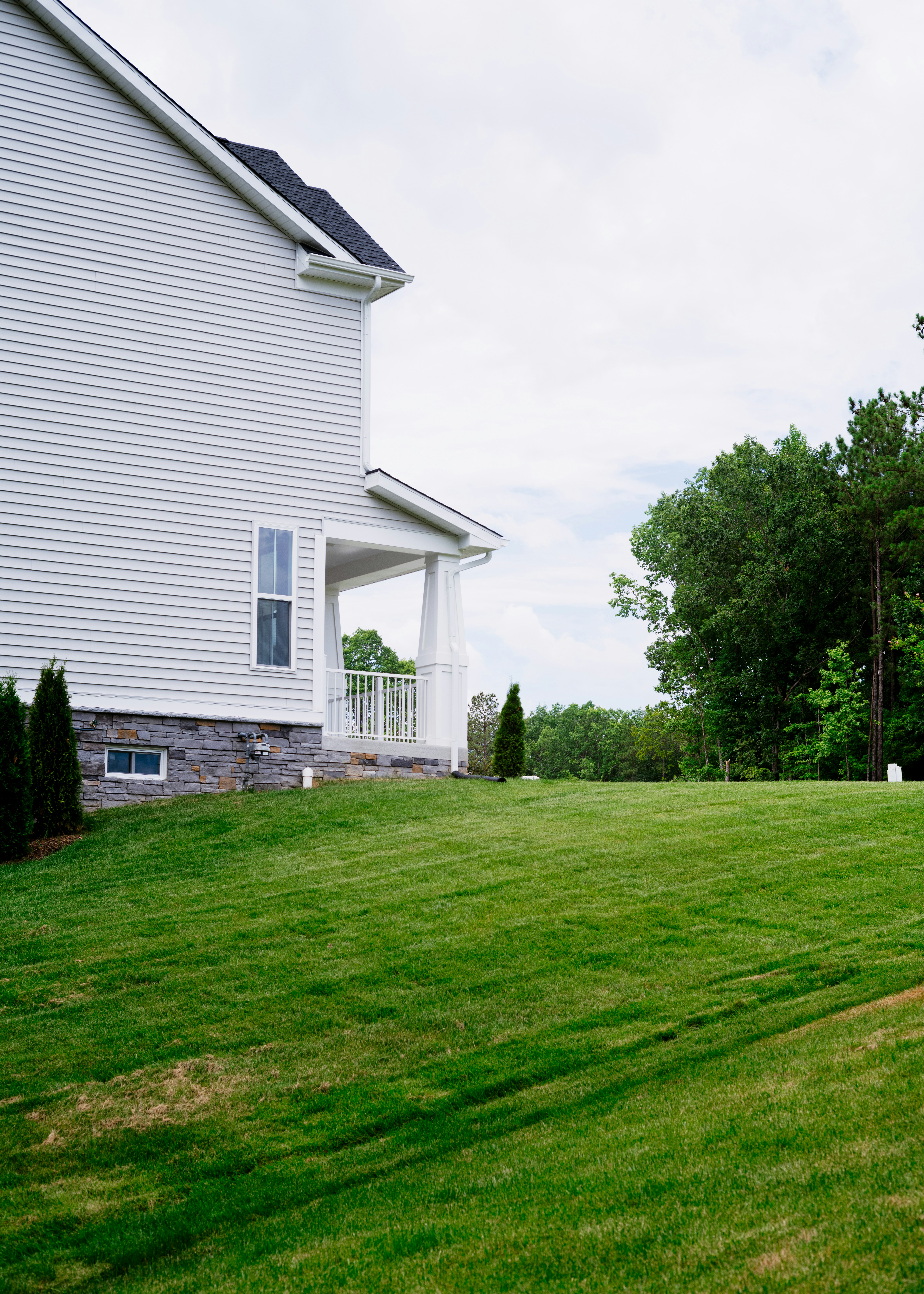 A large yard with a house in the background