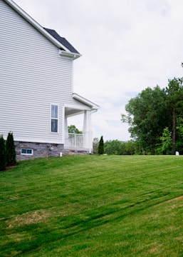 A large yard with a house in the background