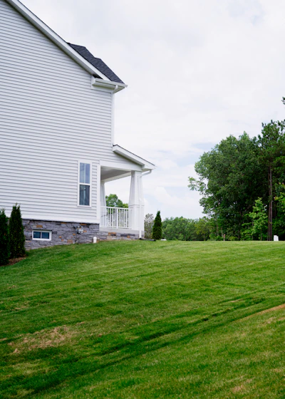 A large yard with a house in the background