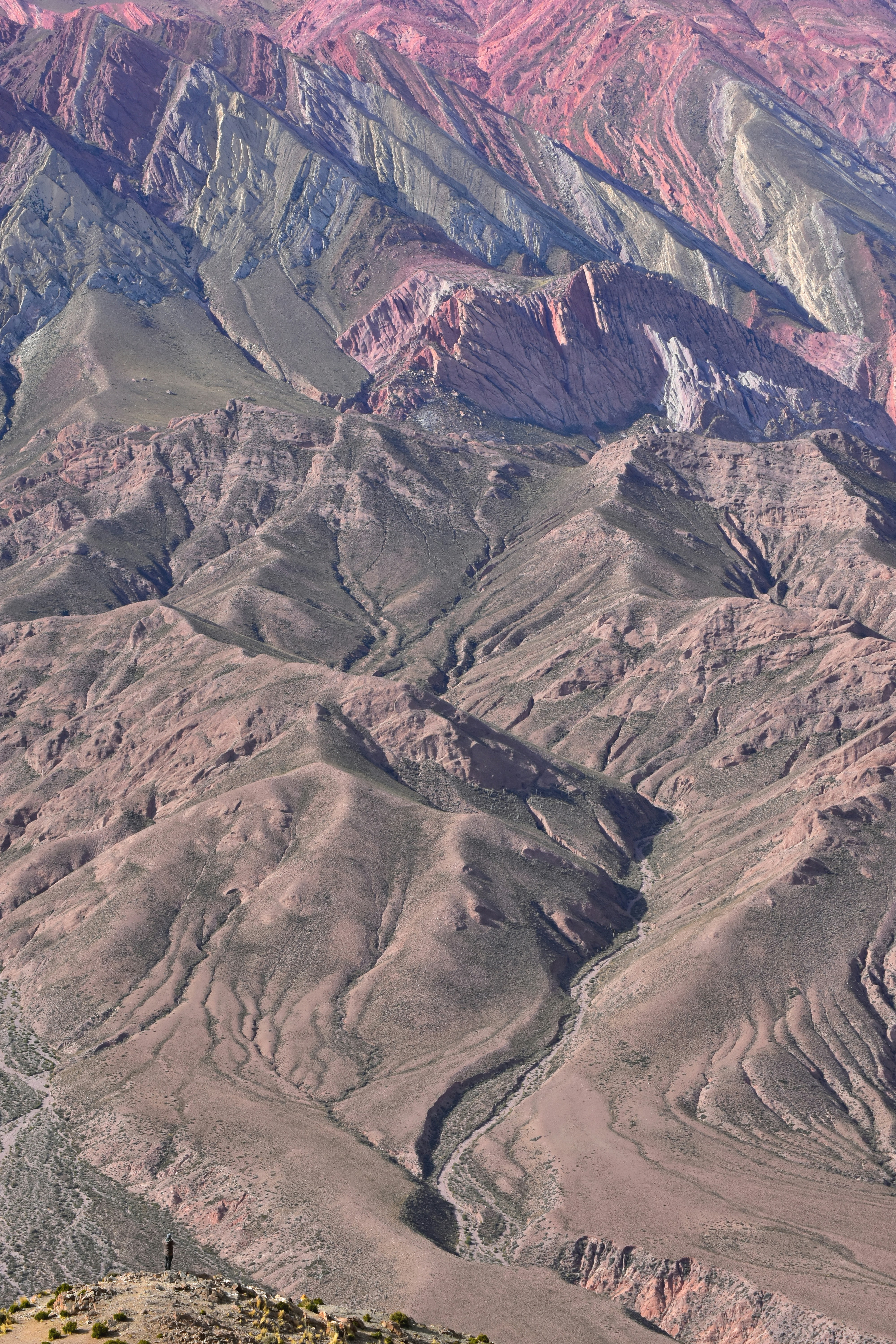 A man standing on top of a mountain with a backpack