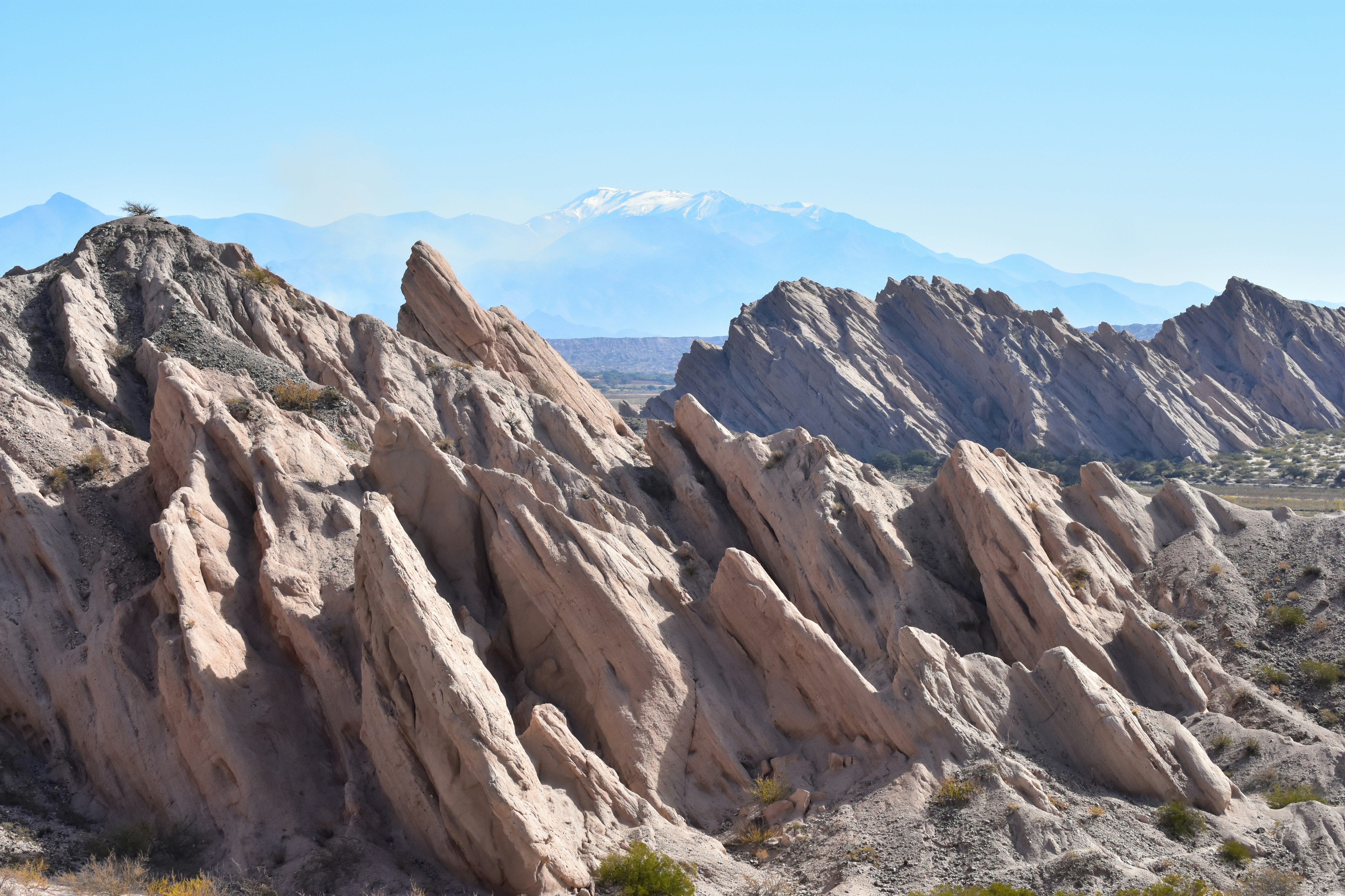 A mountain range with many large rocks in the foreground