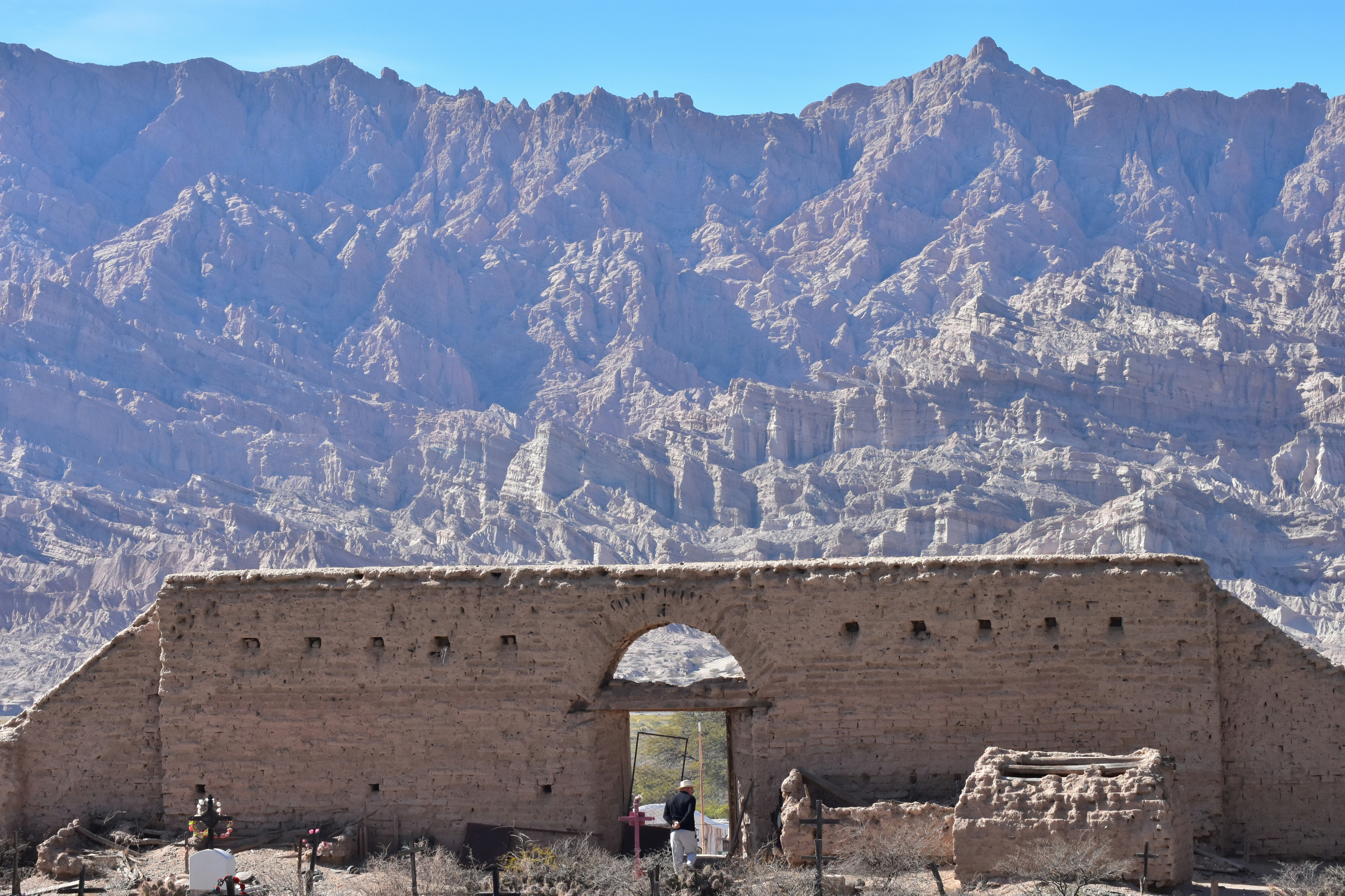 A large building with a mountain in the background