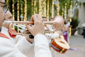 A man playing a trumpet in front of a group of people