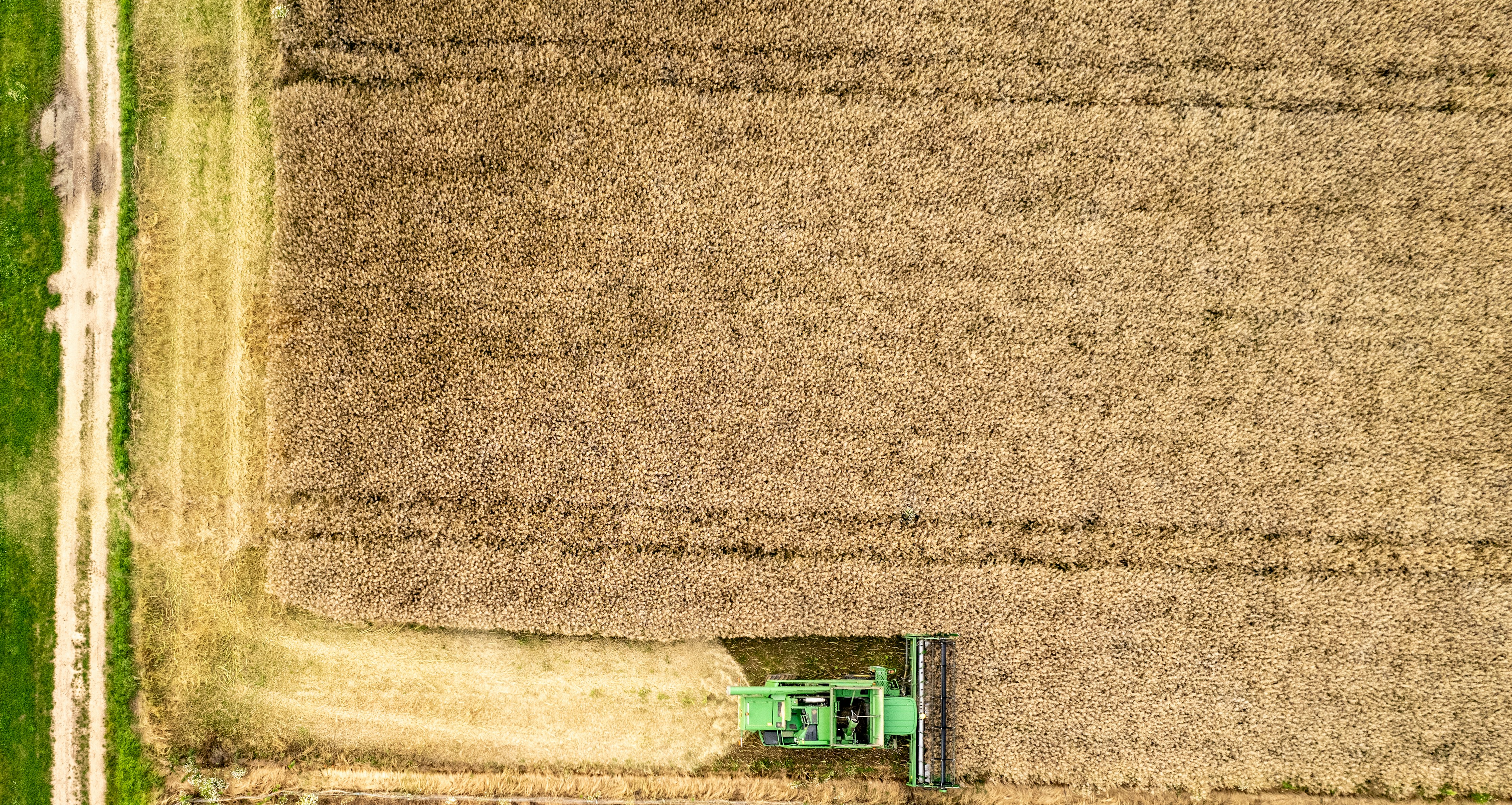 An aerial view of a farm field with a tractor
