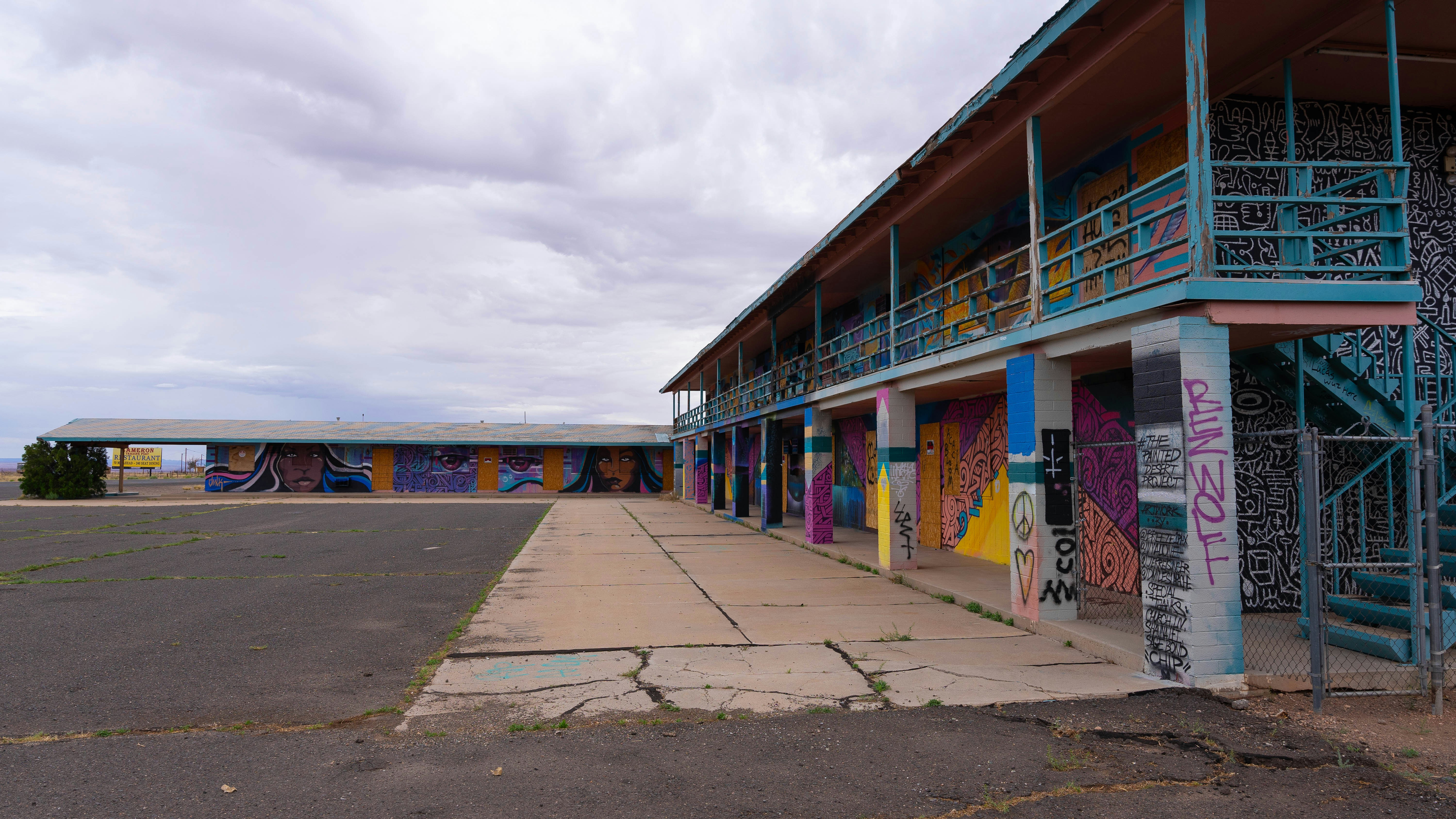 A parking lot with a row of colorful buildings