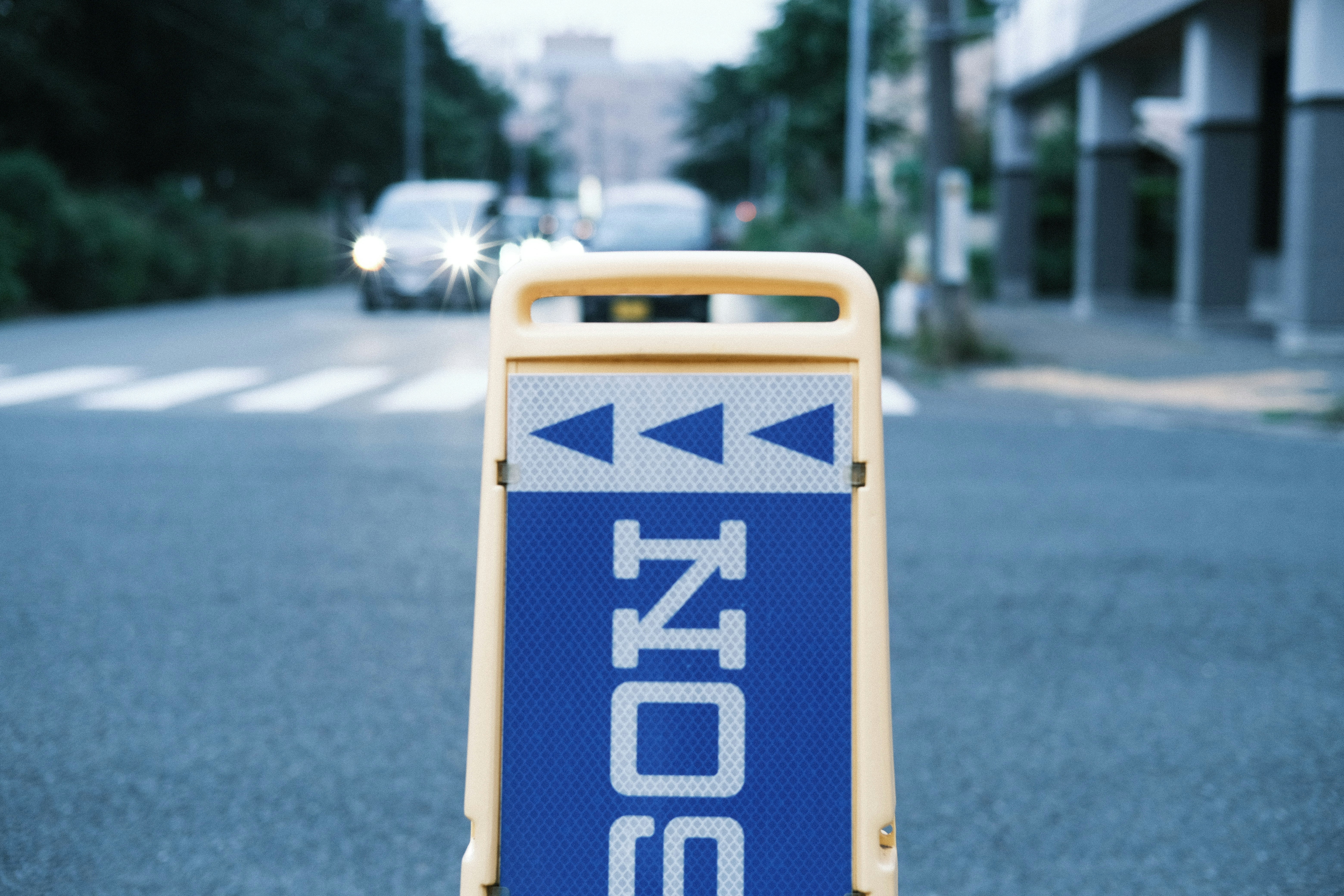 A blue and white sign sitting on the side of a road
