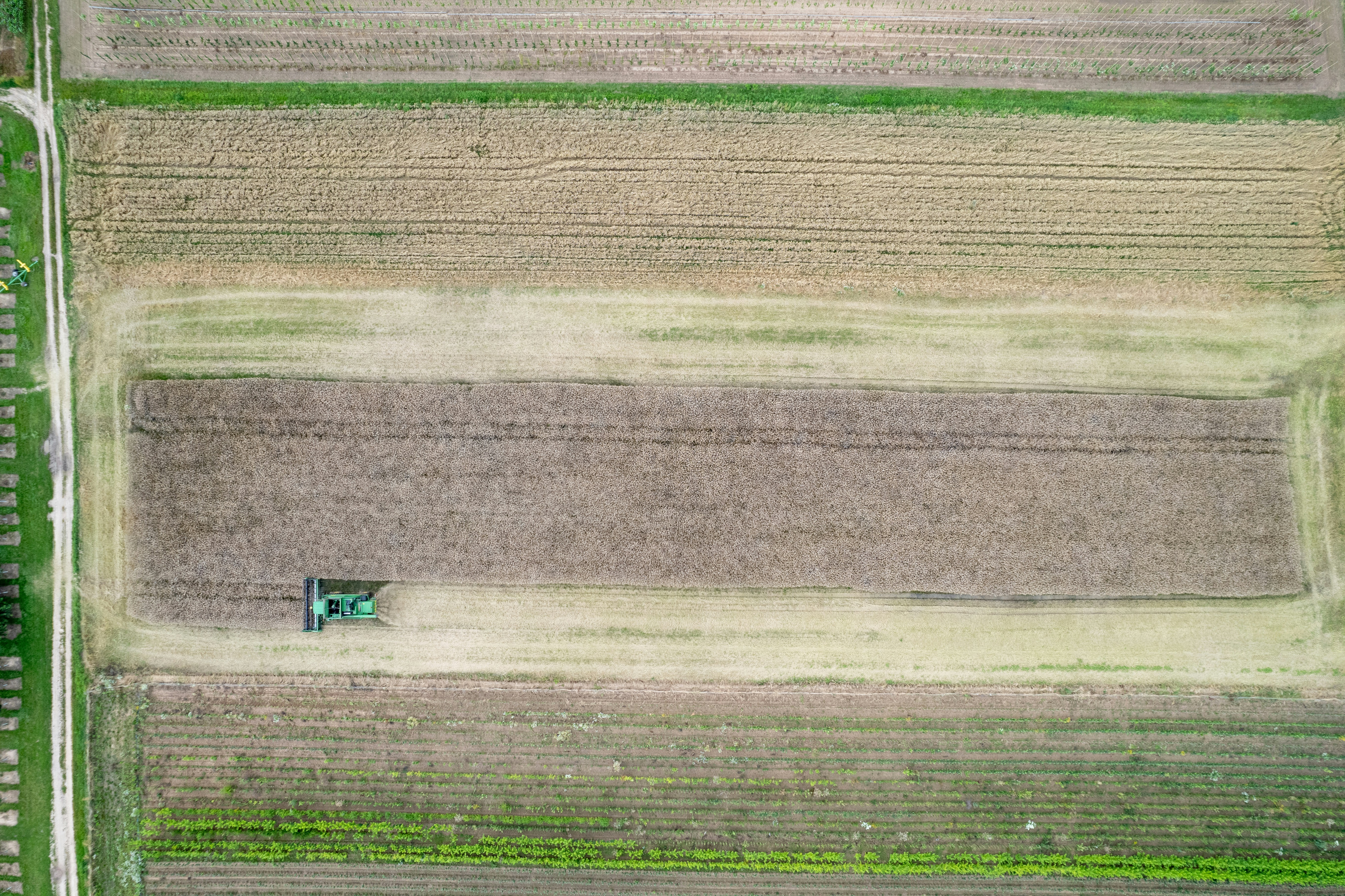An aerial view of a field with a tractor in it