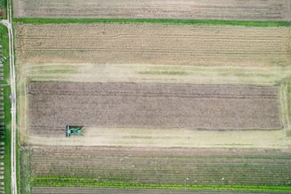 An aerial view of a field with a tractor in it