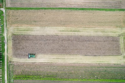 An aerial view of a field with a tractor in it