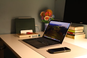 A laptop computer sitting on top of a white desk