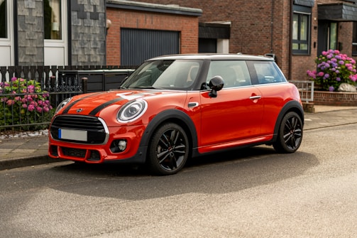 A red mini cooper parked on the side of the road