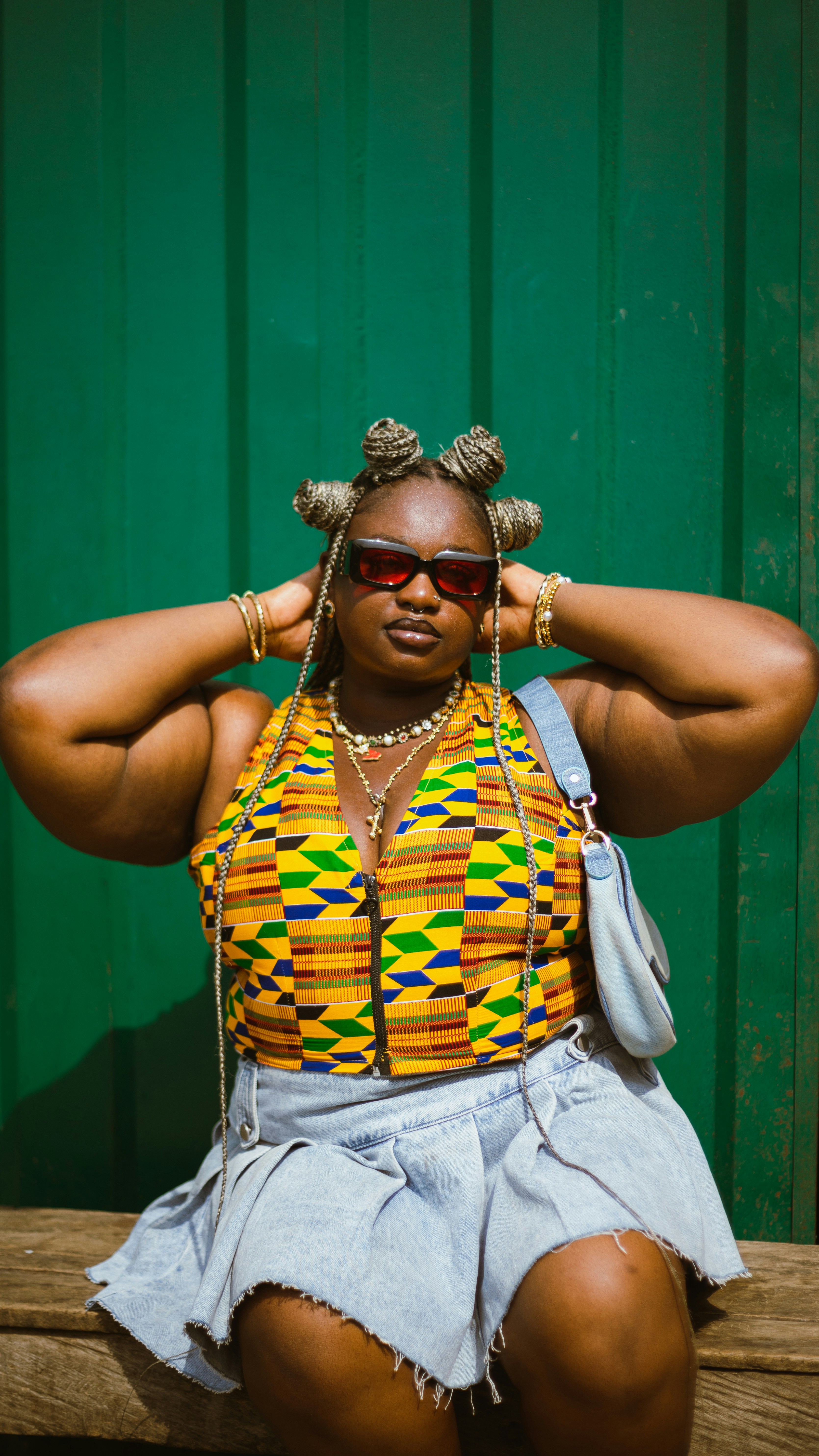 A woman sitting on top of a wooden bench