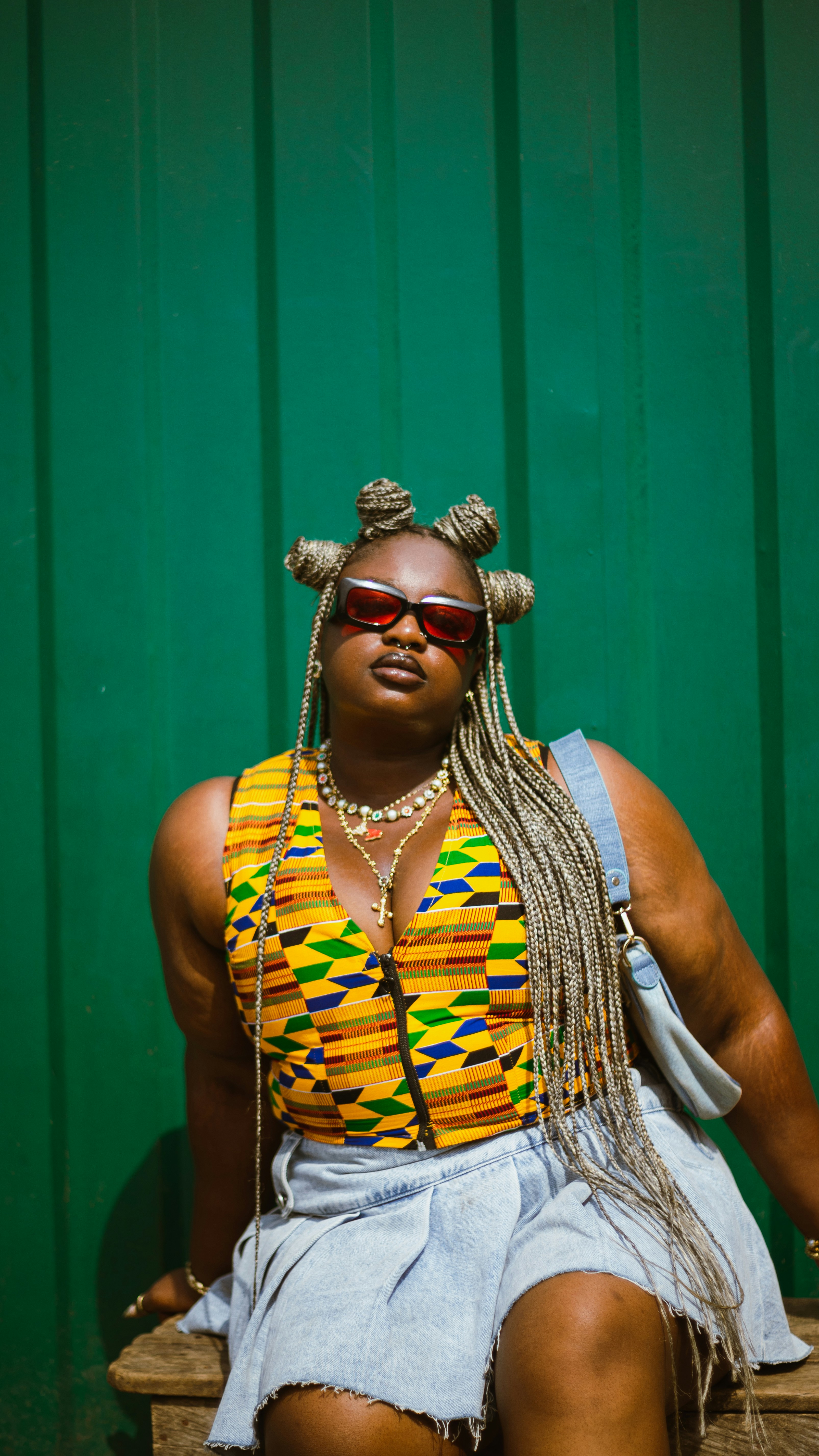 A woman sitting on top of a wooden bench