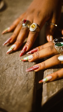 A close up of a person's hands with rings on them