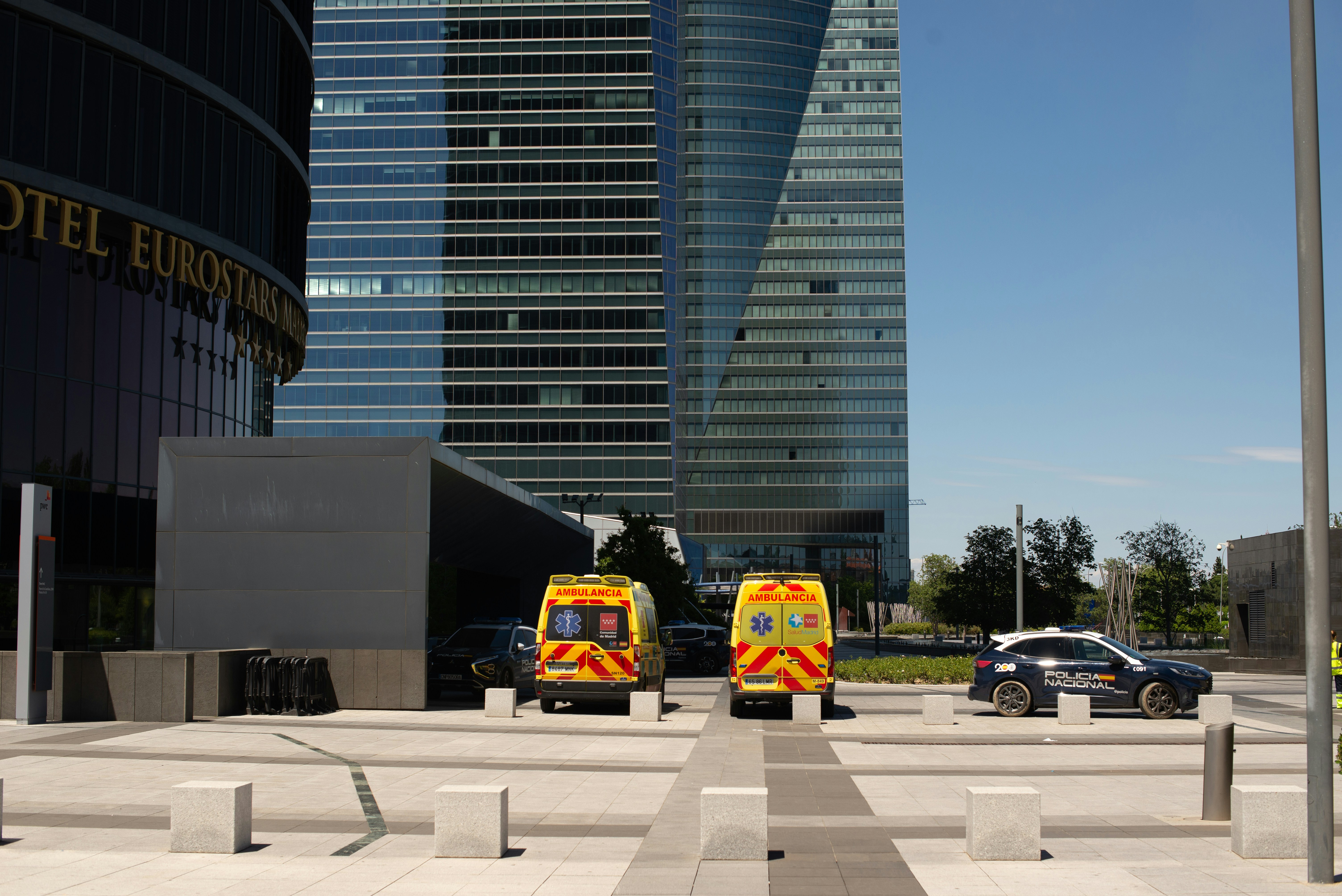 A couple of trucks parked in front of a tall building