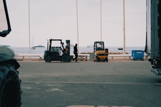 A forklift is parked in front of a truck