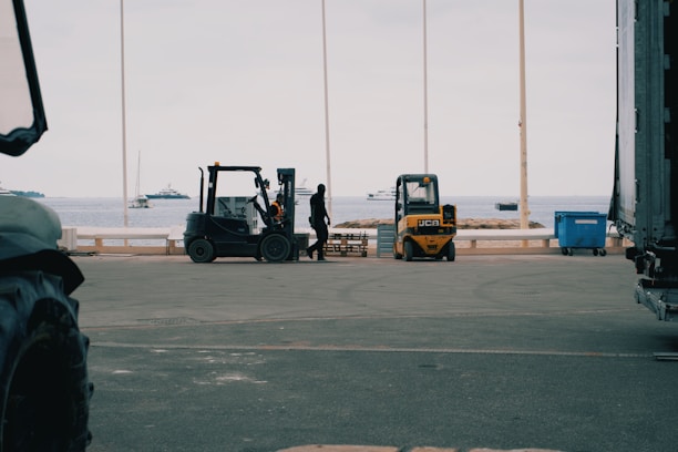 A forklift is parked in front of a truck