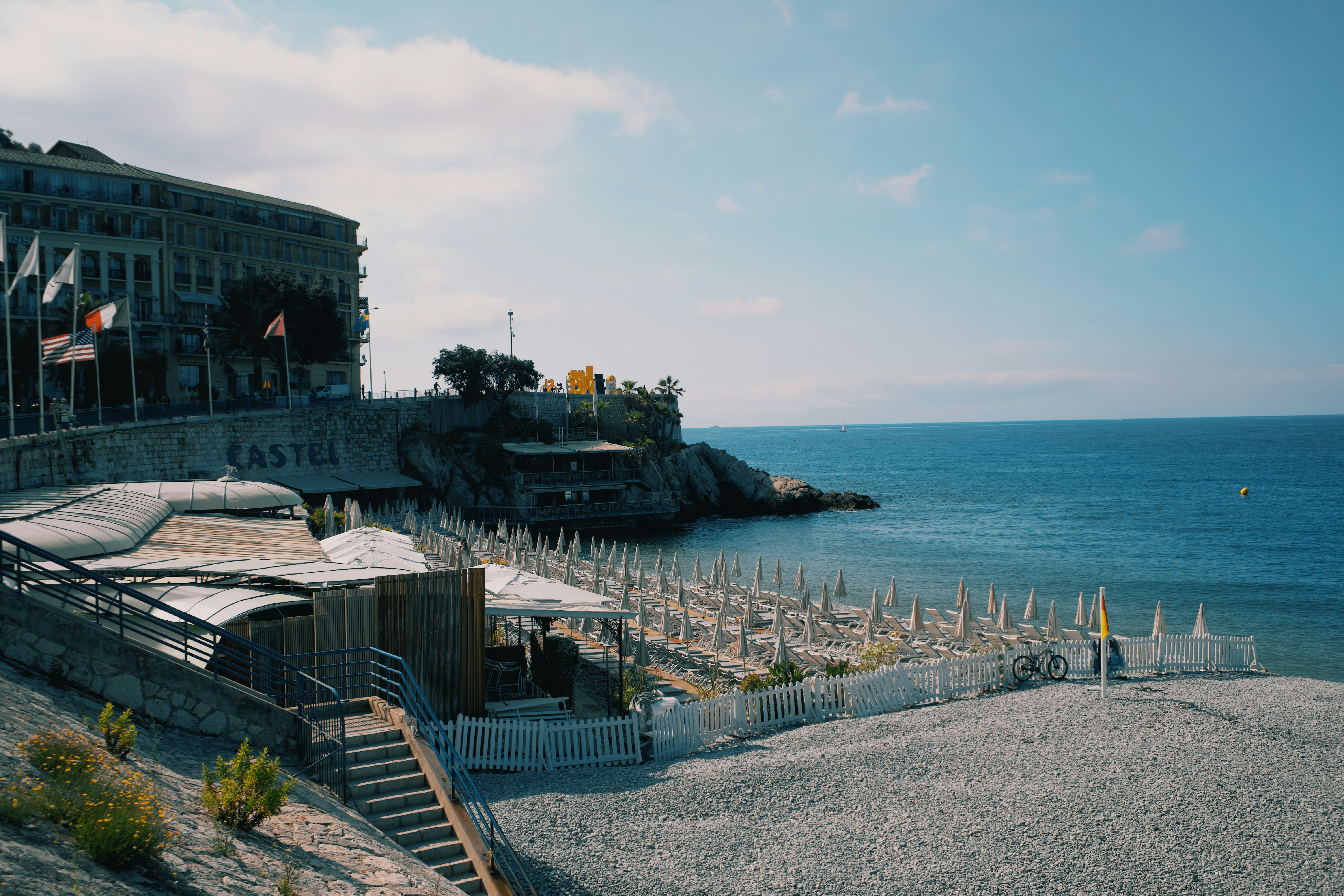 A view of a beach with a building in the background, 