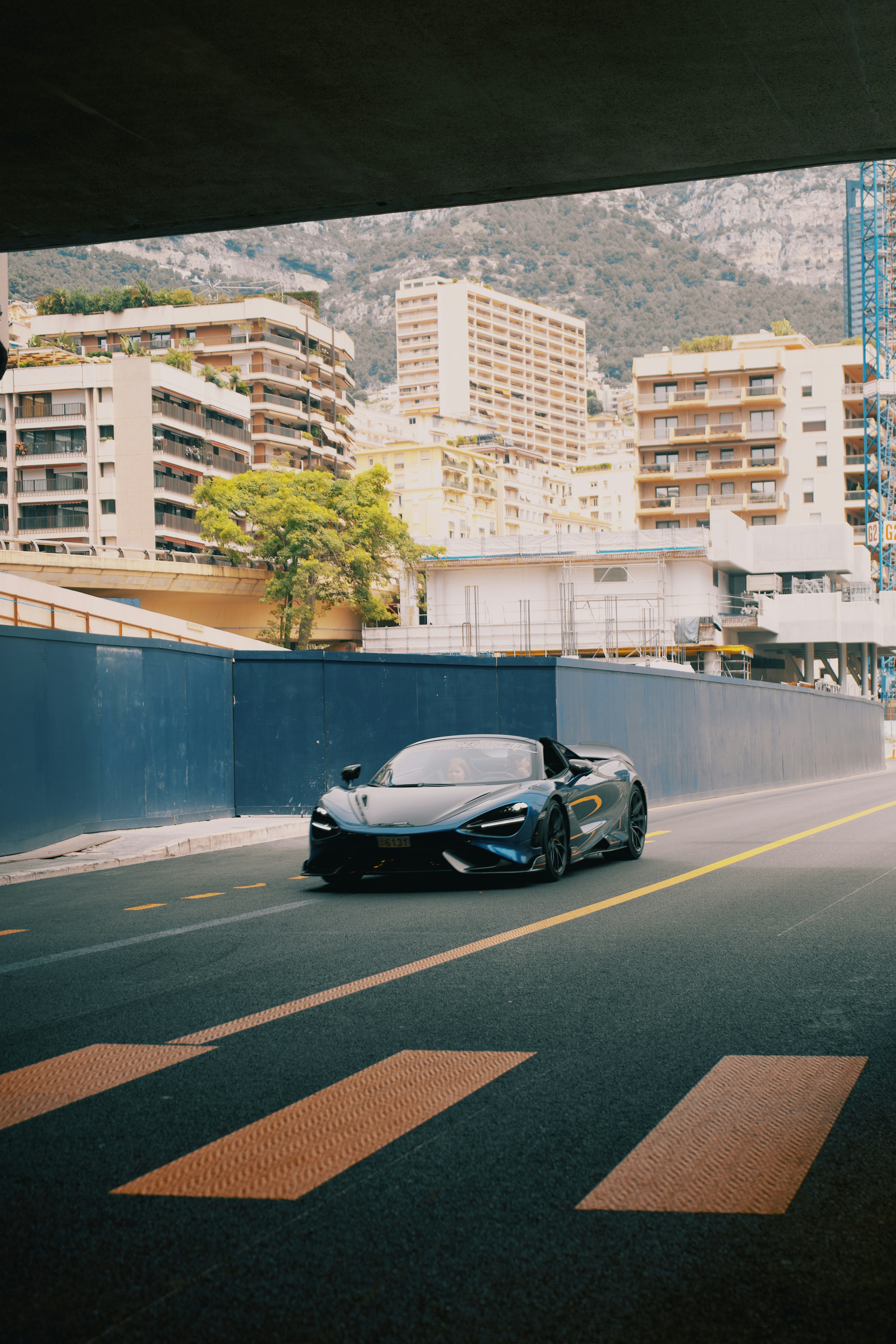 A black sports car driving down a city street photo – Free Cars Image ...
