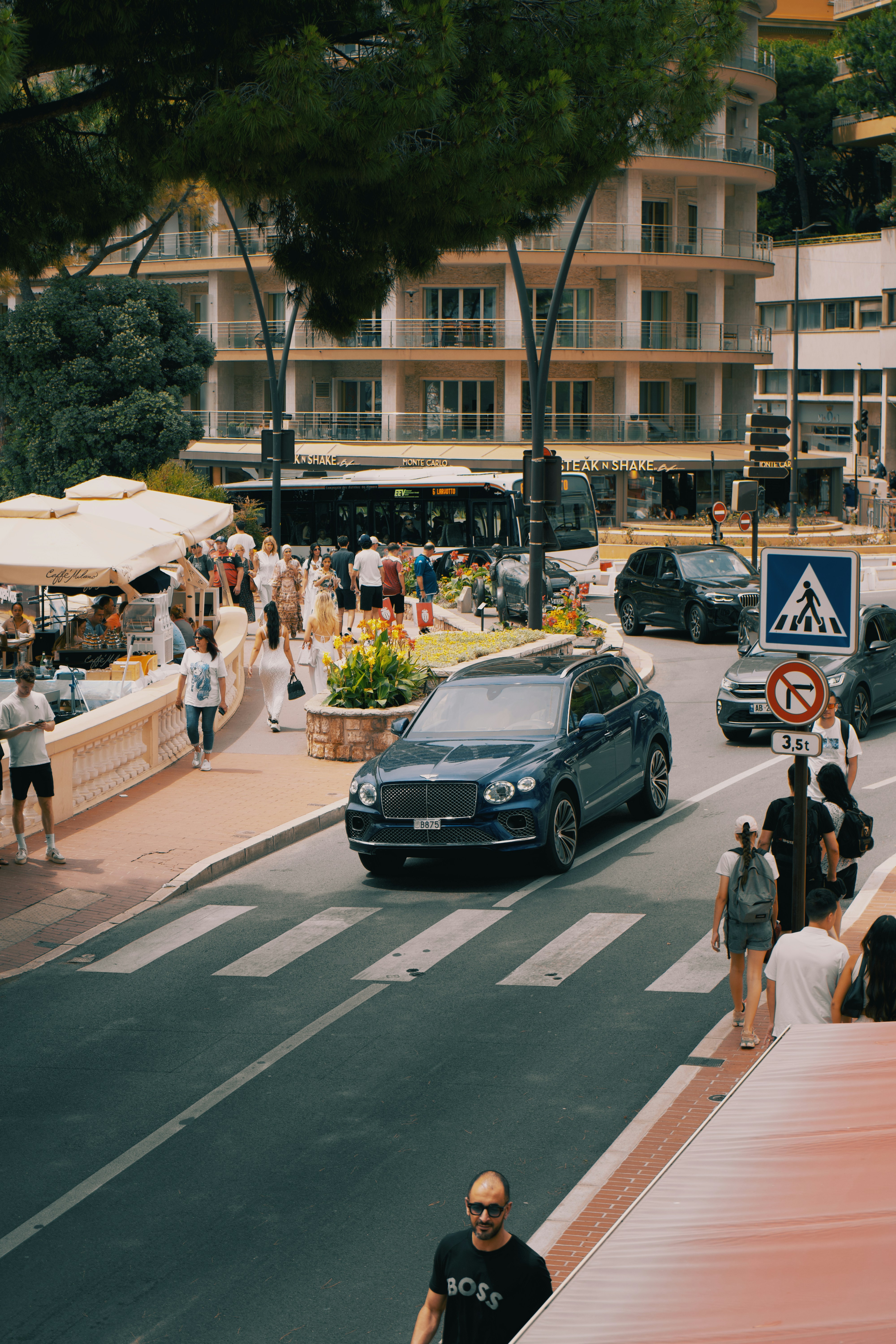 A busy city street with cars and people