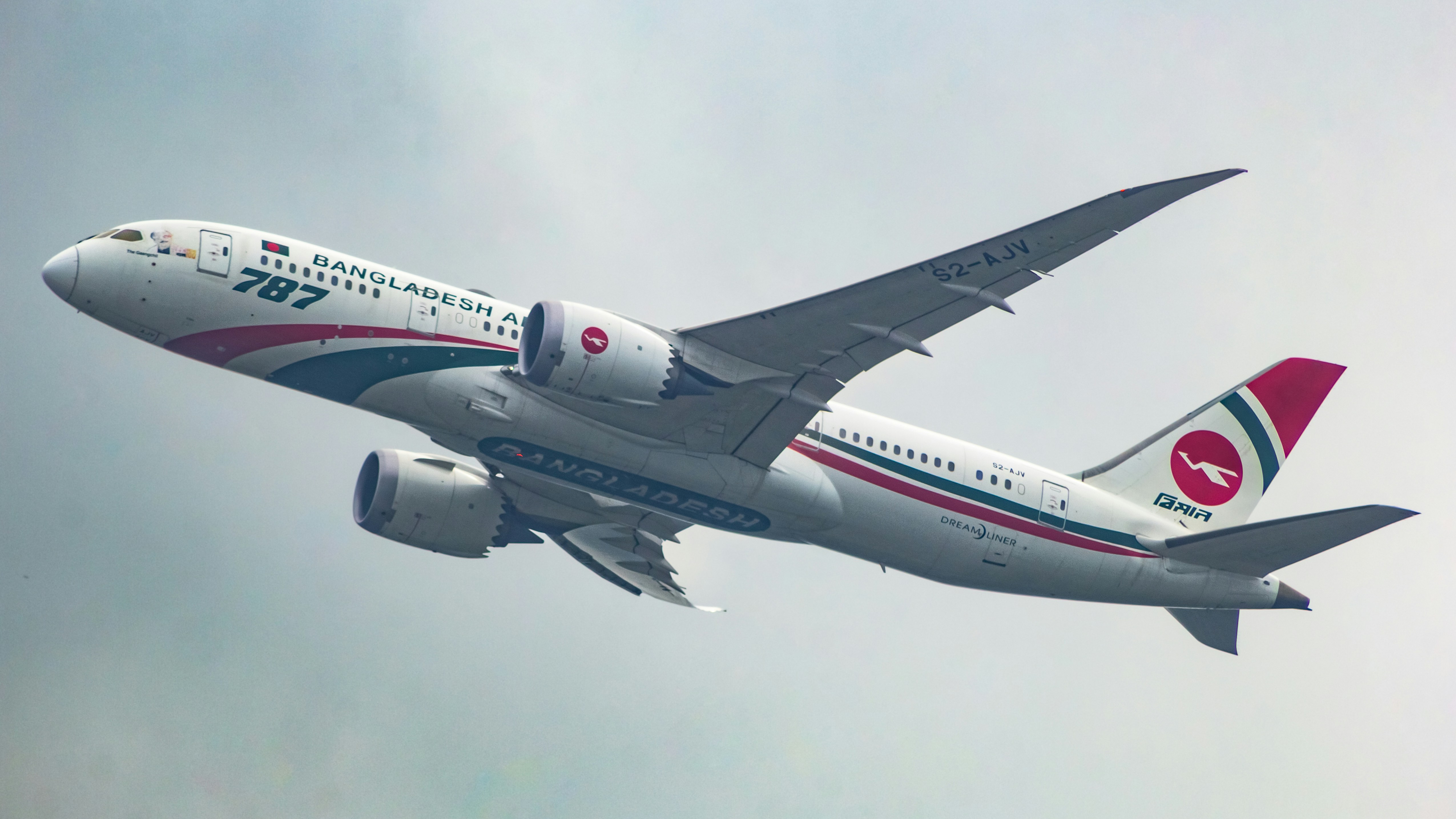 A large jetliner flying through a cloudy sky