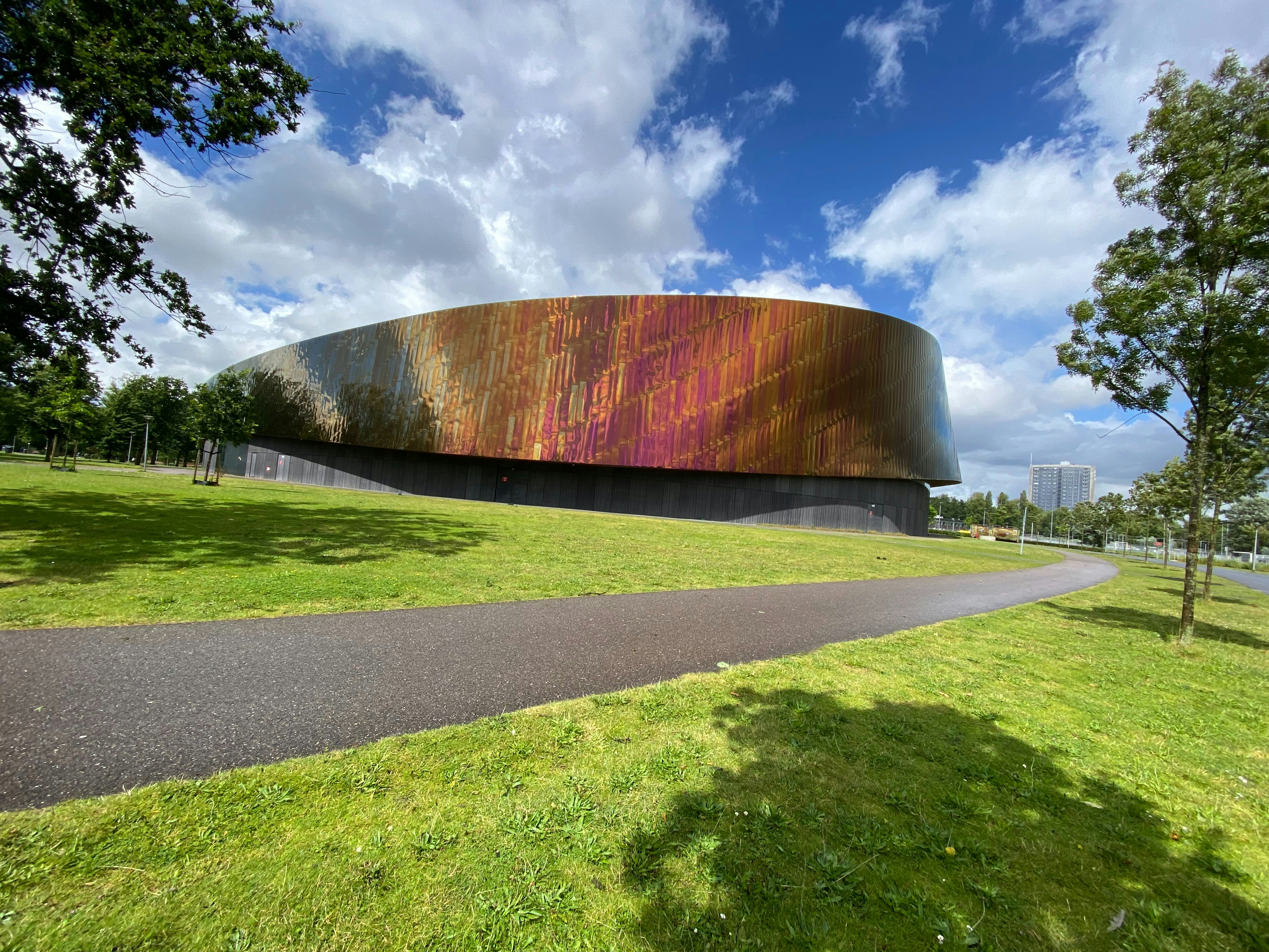 A large metal structure sitting on top of a lush green field