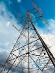 A high voltage power line against a blue sky