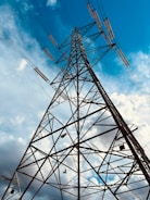 A high voltage power line against a blue sky