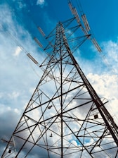 A high voltage power line against a blue sky