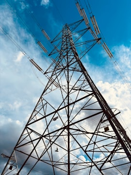 A high voltage power line against a blue sky