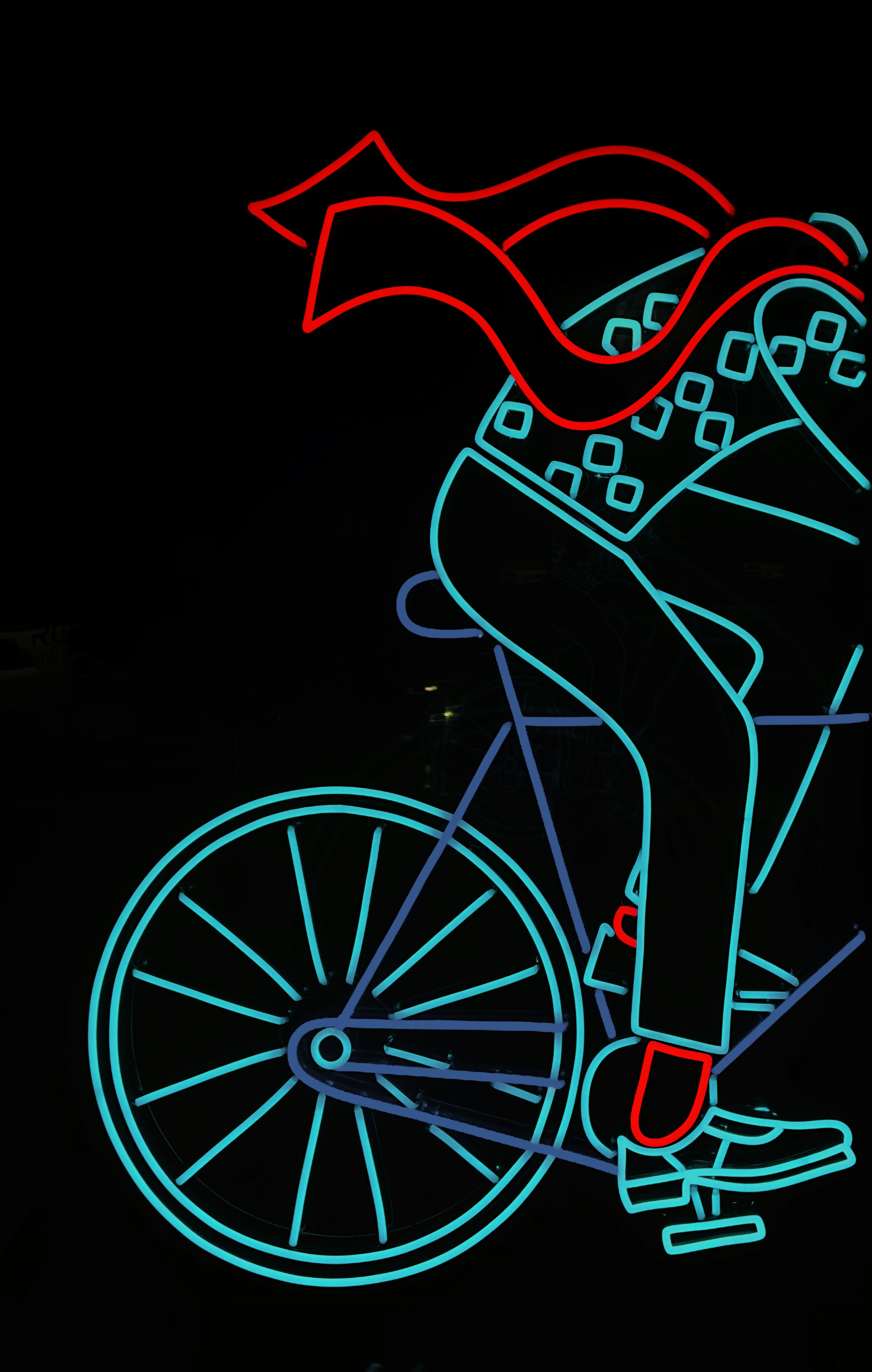 A man riding a bike with a red umbrella