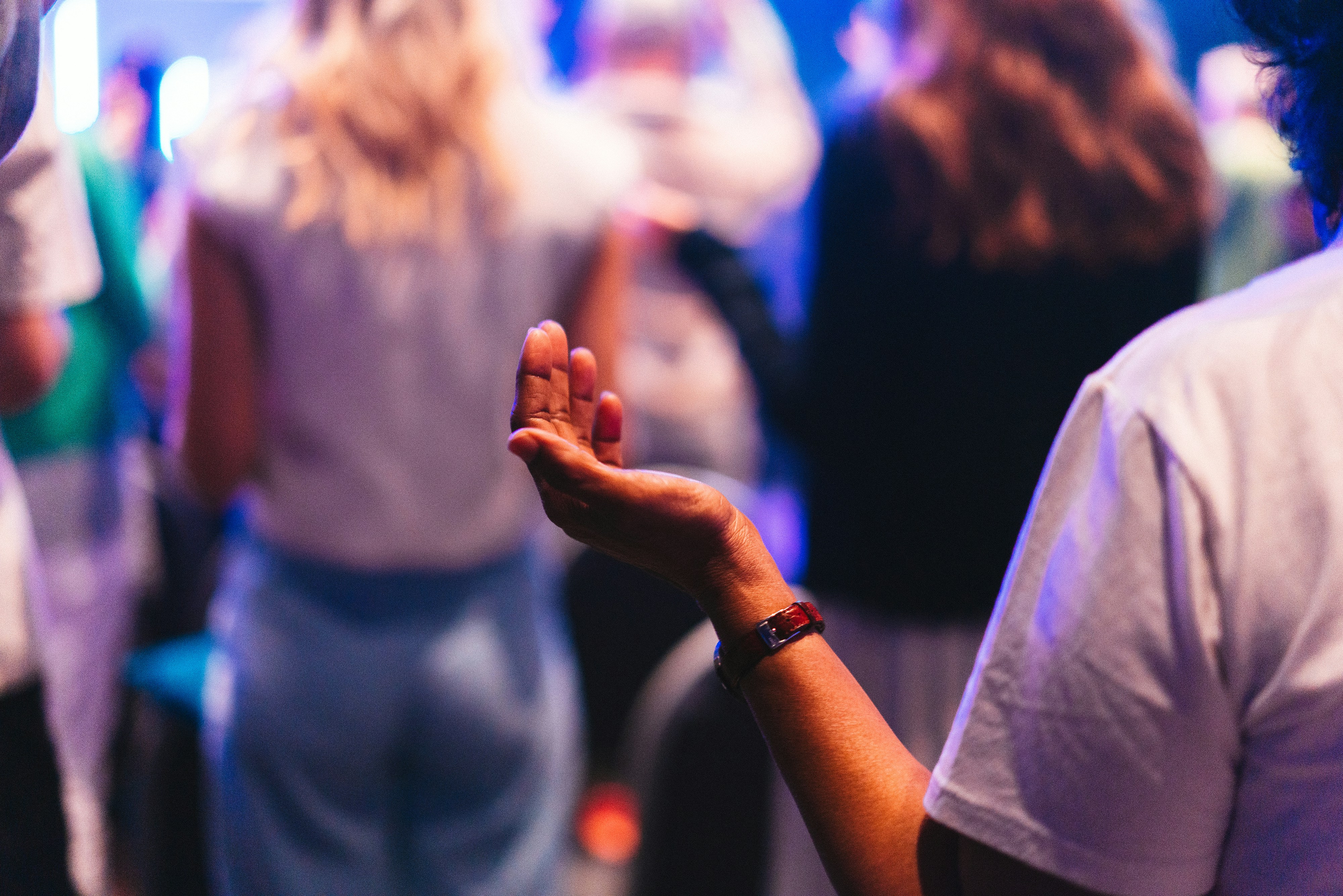 A crowd of people standing around each other