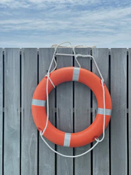 A life preserver hanging on a wooden fence