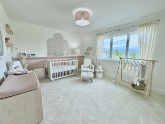 A baby's room with a crib, crib, and rocking chair