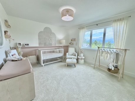 A baby's room with a crib, crib, and rocking chair
