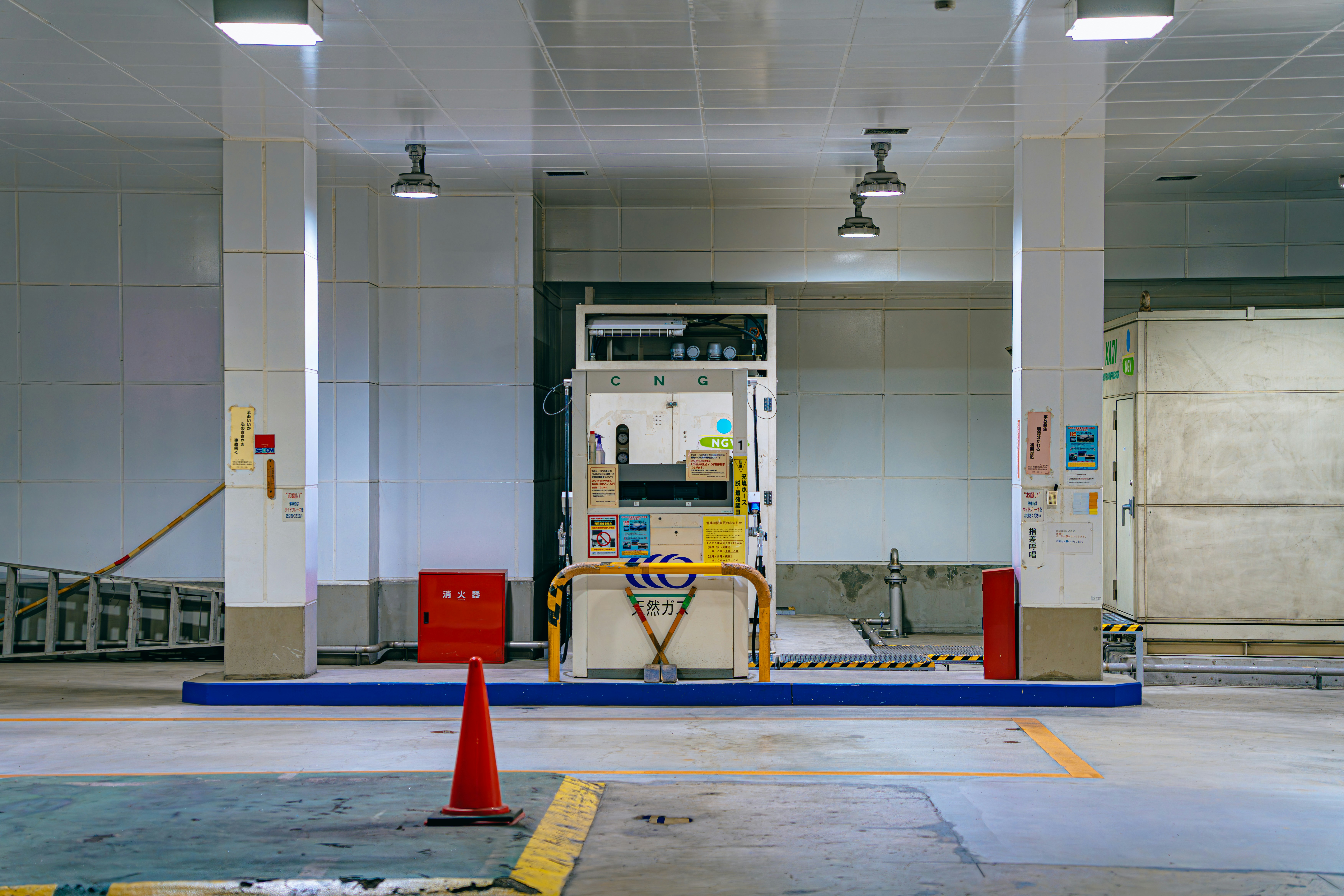 An empty parking garage with a fire hydrant
