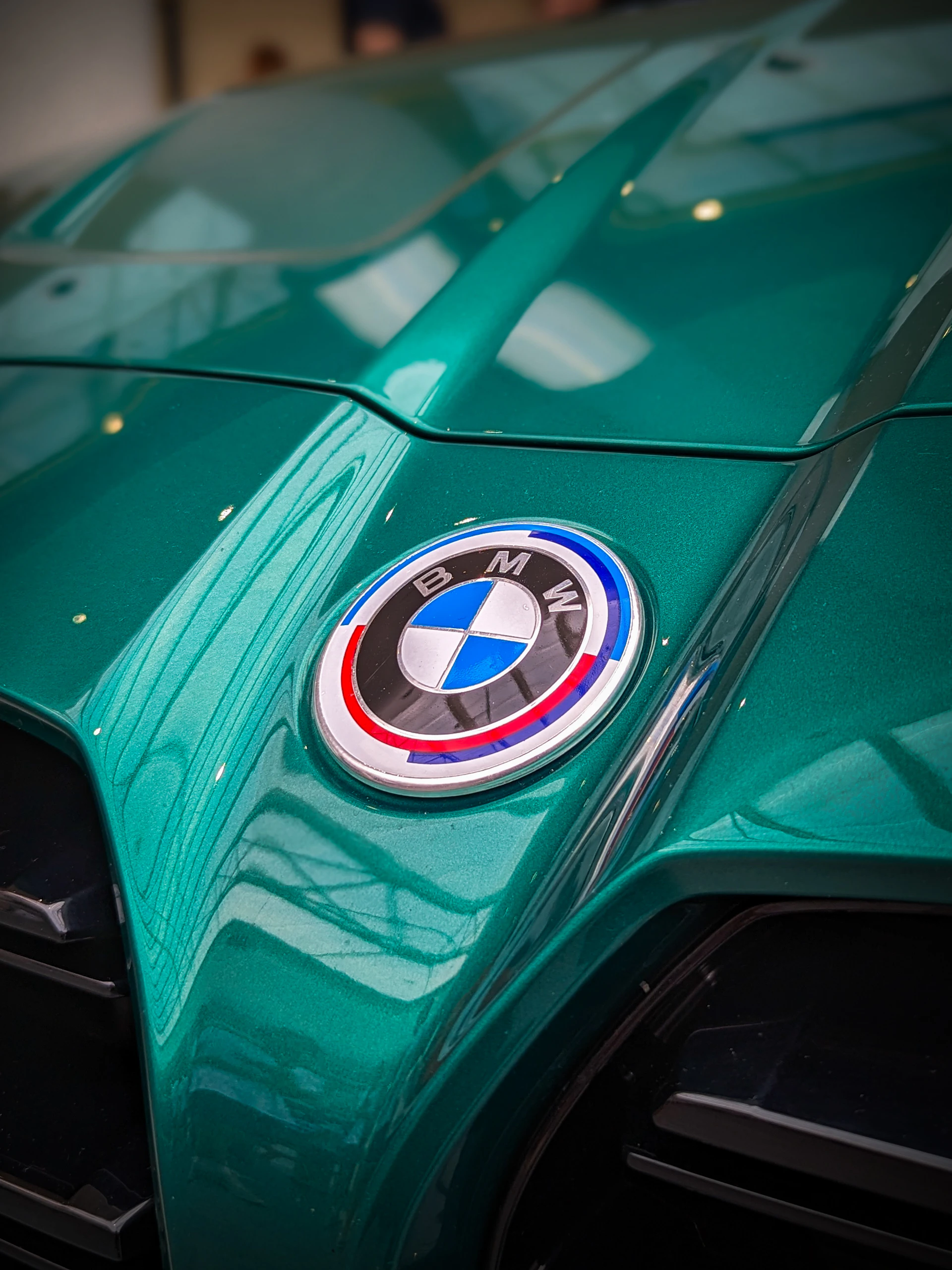 A close up of the front of a green sports car