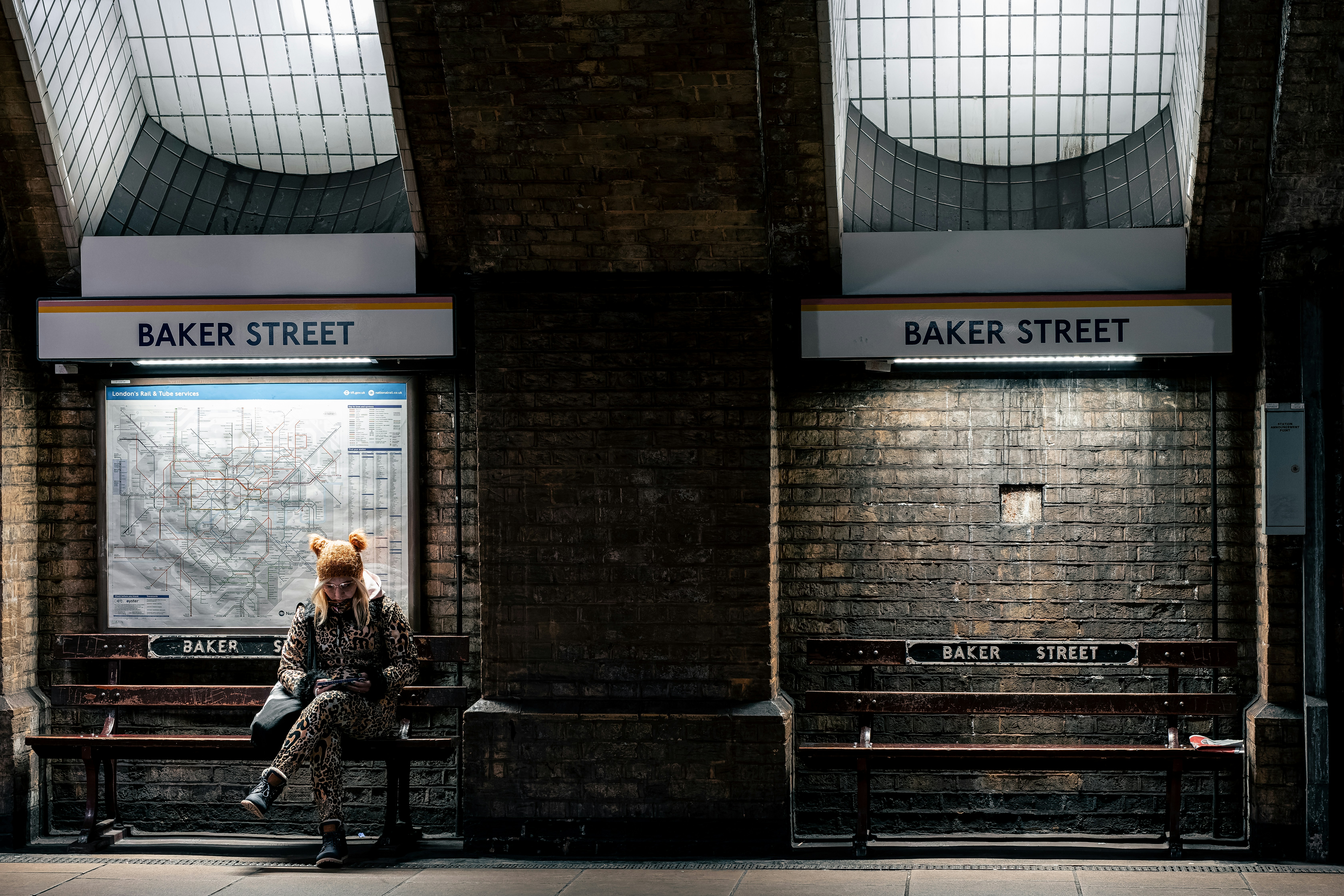 A person sitting on a bench in a train station