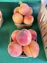 A bunch of peaches sitting on a table