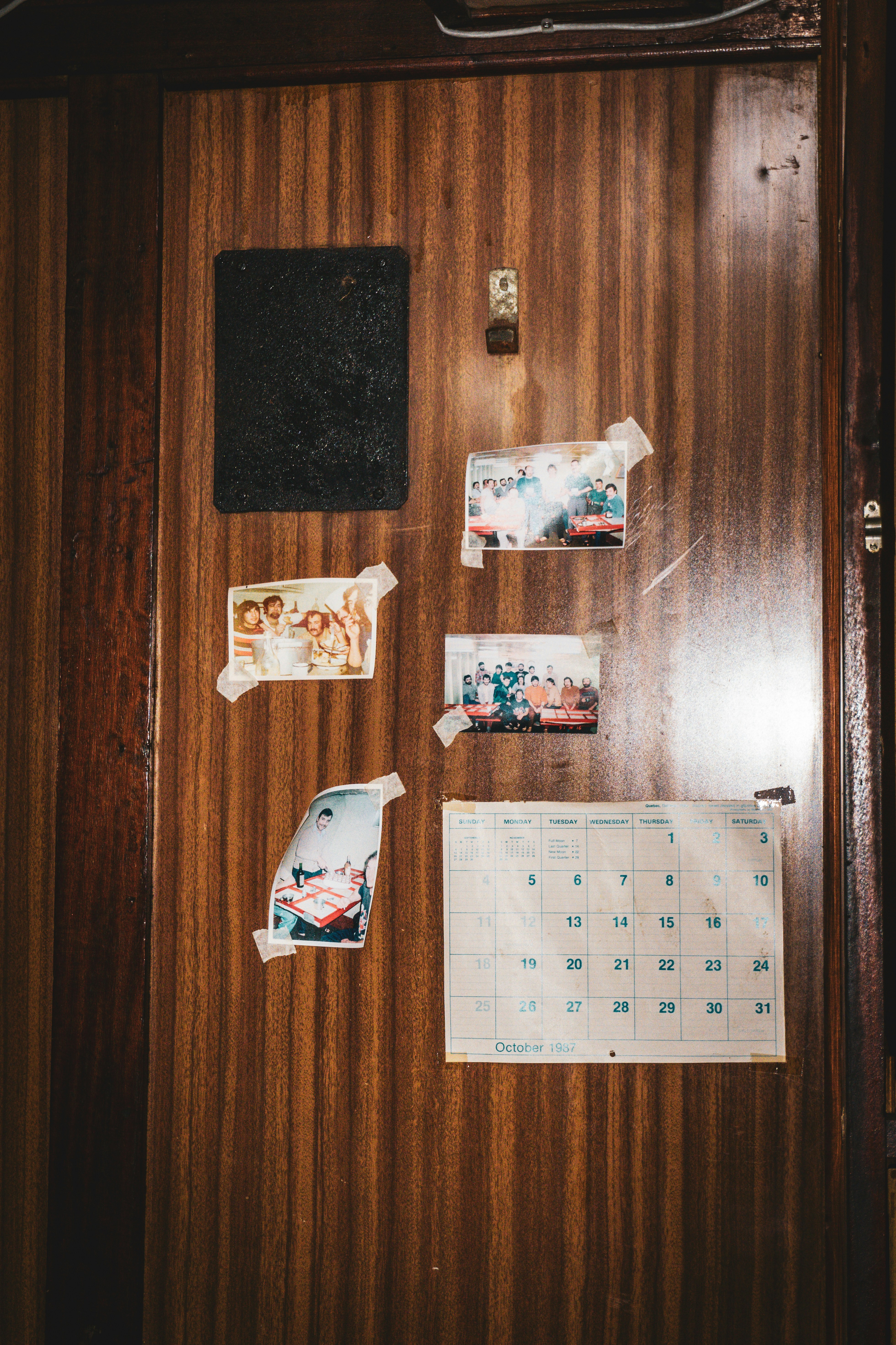 A wooden door with a bunch of stickers on it