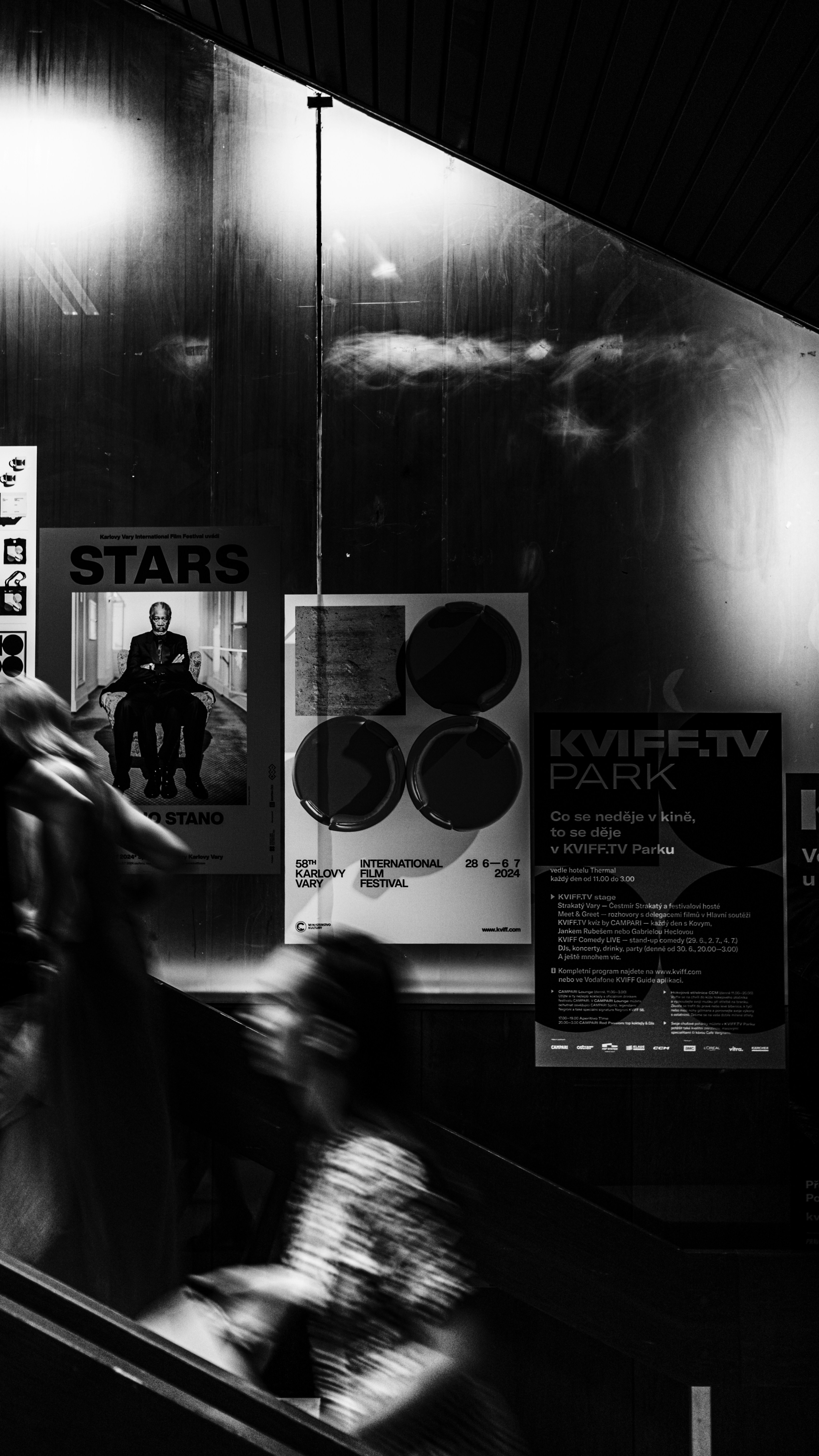 A black and white photo of people on an escalator